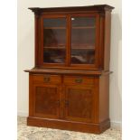 Victorian mahogany bookcase on cupboard, bead cornice above two glazed doors with columns,