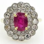 18ct Gold and platinum Cluster Ring set with an oval facet cut ruby surrounded by two tiers of
