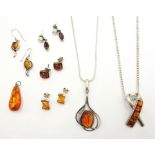 Silvered metal Pendant with an amber panel, another and five other amber items.