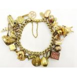 18ct Gold Curb Link Bracelet hung with various gold charms. (88.