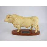 Beswick model of a Charolais bull from the Connoisseur Series on a wooden plinth No.