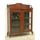 Early 20th Century mahogany Display Cabinet with inlaid decoration and serpentine outline enclosed