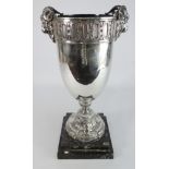 Continental plated vase shape Trophy with rams head handles on a pedestal foot and marble base,