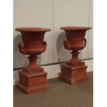 Pair large campana-shaped garden urns, body with scrolling foliage centred with flowers,