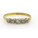 18ct Gold Ring with five diamonds in a rubover setting, unmarked but tests as 18ct.