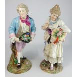 Pair of late 19th Century Continental porcelain standing figures of a Dandy and his lady,