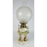 Thuringian Table oil Lamp, the base with encrusted flowers and on cherub supports, H51cm.