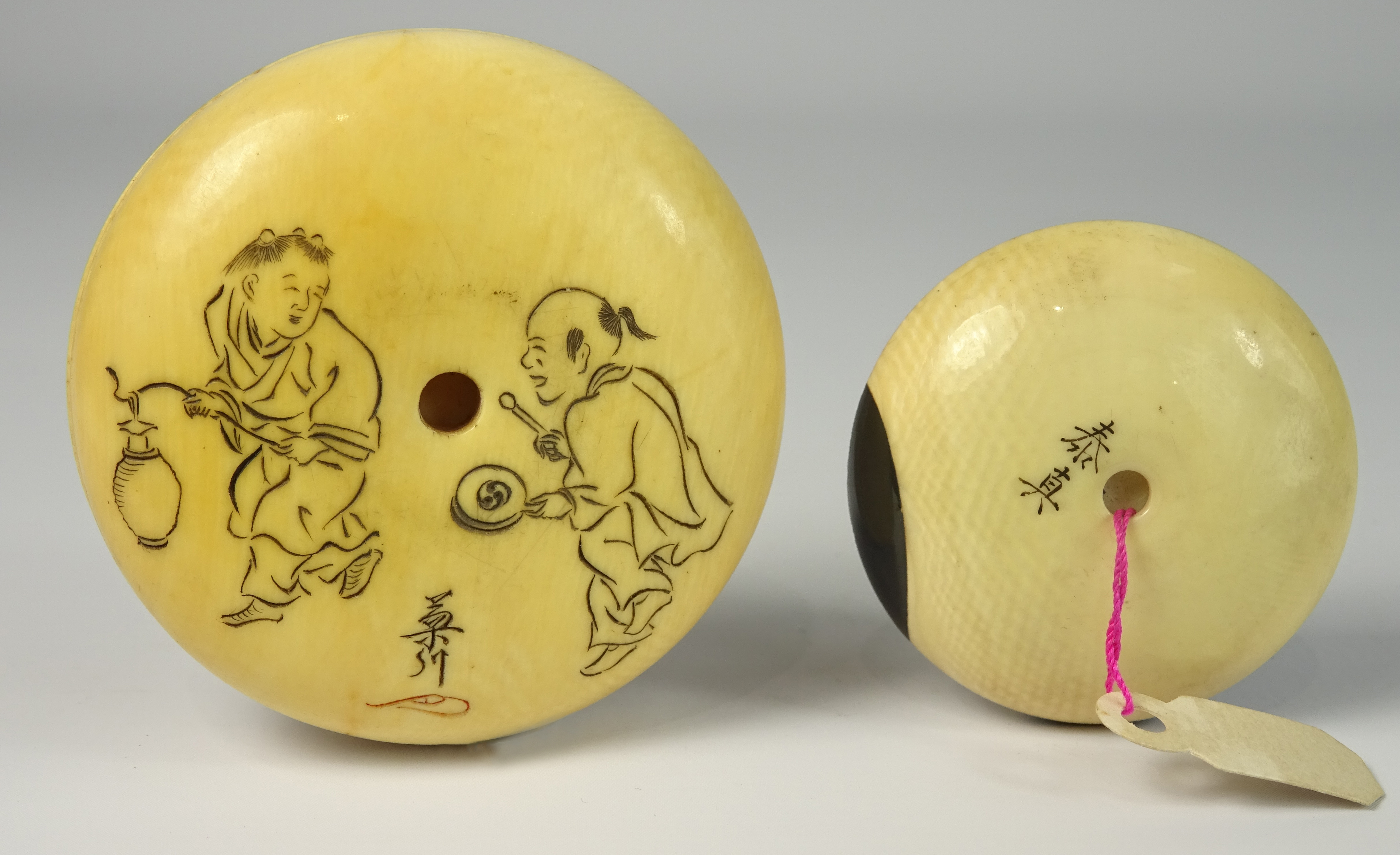 Japanese ivory Kagamibuta Netsuke carved with figures and with further figures and signature to the - Image 2 of 2