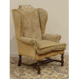 Georgian style walnut framed wingback armchair, upholstered in 18th century style needlework cover,