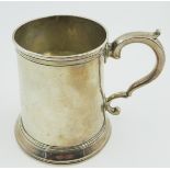 Early George III silver Mug with reeded edge, sea scroll handle and engraved with a crest of arrows,