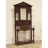 Early 20th century oak hall stand, heavily carved with masks, scrolls and lunettes,