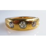 Gold ring set with three diamonds, unmarked.