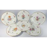 Set of six Royal Copenhagen plates decorated with sprays of flowers within a moulded and gilded