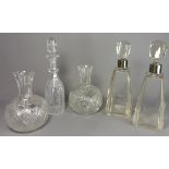 Pair of square glass decanters with facet cut stoppers and plated collars,