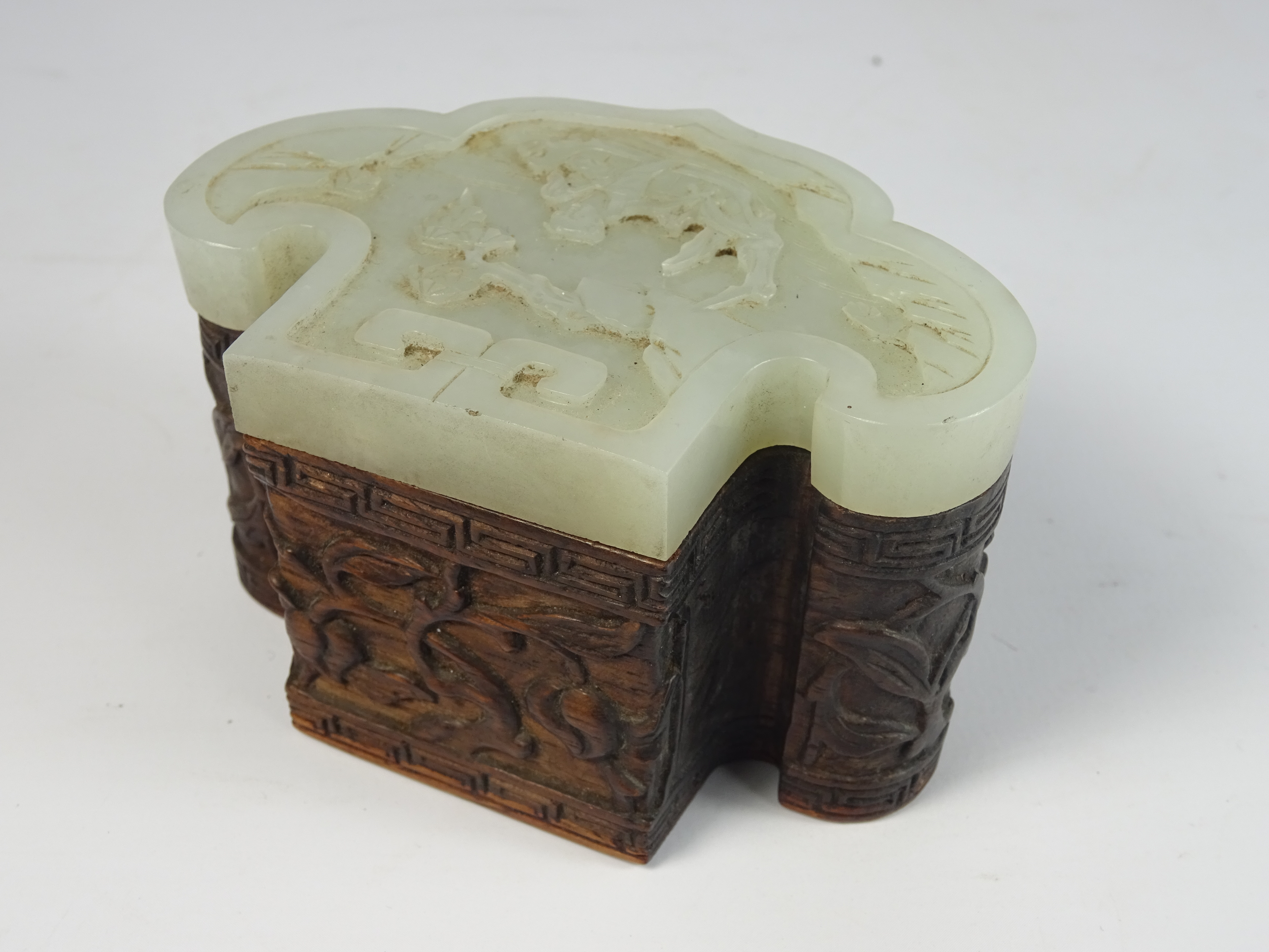 19th / 20th Century Chinese hardwood box with a pale celadon jade Ruyi-form cover carved with a