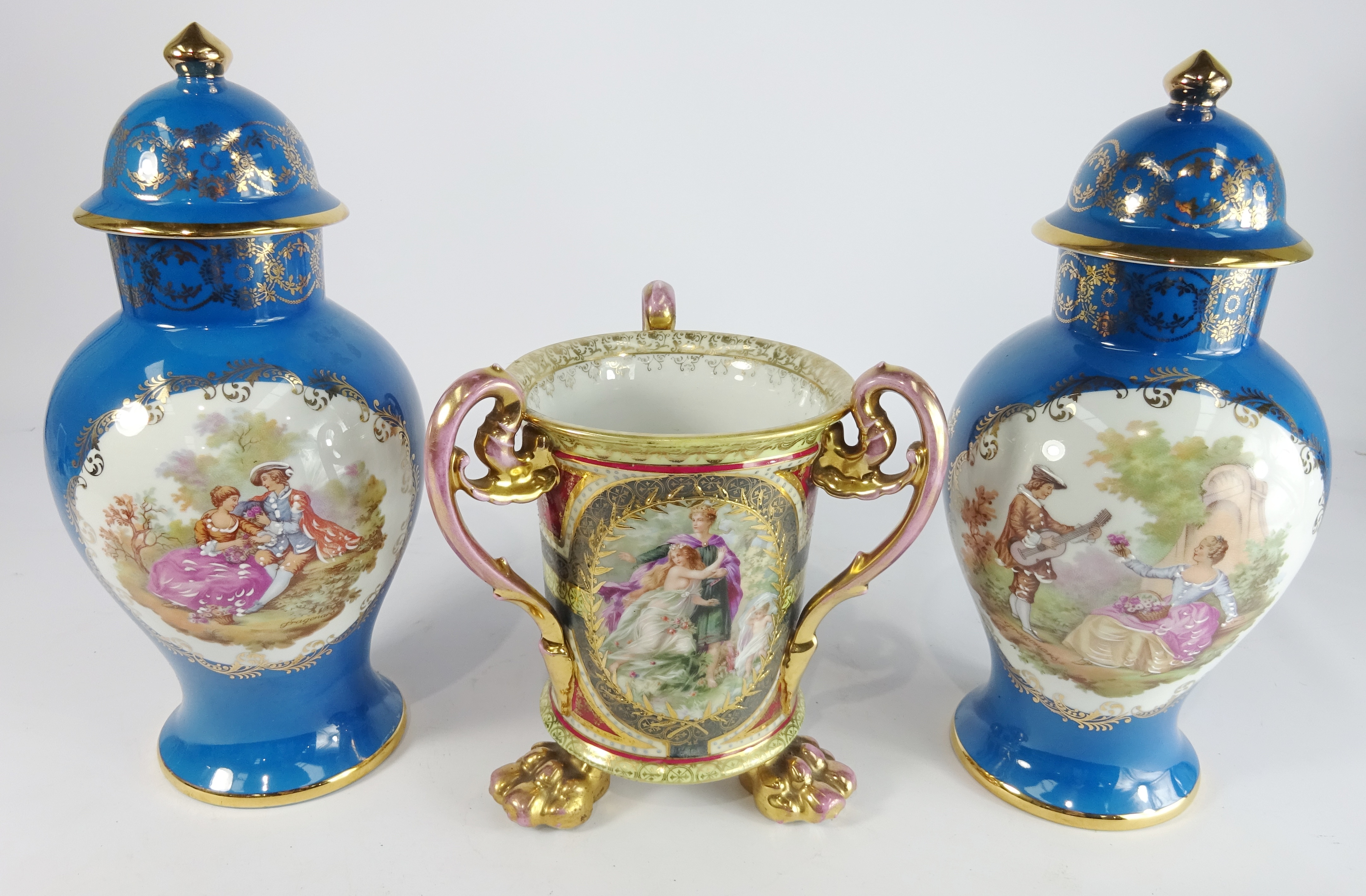 Vienna three handled Vase decorated with panels of classical figures on paw feet,
