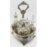 Victorian silver seven division cruet with loop handle and embossed decoration fitted with five