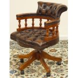 Reproduction walnut framed swivel and reclining captains desk chair upholstered in brown leather