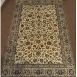 Persian Kashan ivory ground rug, interlacing floral design with orange highlights,