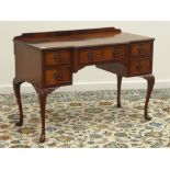 Mid 20th century figured mahogany kneehole desk, five drawers, on shell carved cabriole legs,