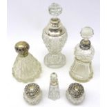 Four Victorian and later cut glass scent bottles and two dressing table jars with silver mounts all