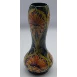 William Moorcroft vase decorated with the revived cornflower pattern in peach and on a green ground