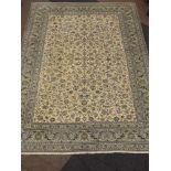 Large Persian Kashan carpet, ivory ground with pale border, scrolling floral overall design,