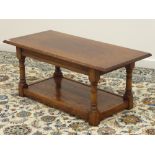 Medium oak coffee table, rectangular moulded top, on turned supports with undertier, 107cm x 51cm,