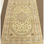Persian Nain ivory ground, blue scrolled design with medallion,