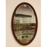 Edwardian inlaid mahogany oval wall mirror with bevelled glass,