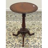 19th century walnut wine table, circular top with carved rim, on twist column,