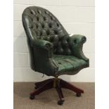 Reproduction mahogany framed swivel office desk chair, upholstered in green buttoned leather,