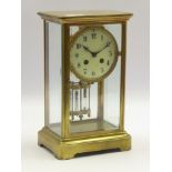 Early 20th century brass and four glass mantel clock, circular enamel Arabic dial,