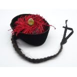 Chinese black velvet Mandarin's hat with fringe and glass and metal ornament,