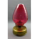 19th century squat brass oil lamp with large cranberry glass shade,