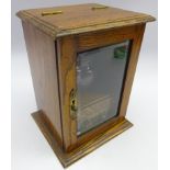 Edwardian oak smokers cabinet with single drawer and a glazed door,