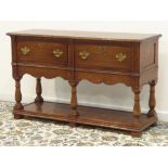 Medium oak dresser base, moulded rectangular top, two drawers above shaped apron,