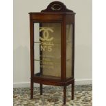 Edwardian mahogany bow front display cabinet, raised shaped back with bevelled mirror,