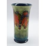 William Moorcroft cylindrical vase decorated with the leaf and berry patterns on a shaded green