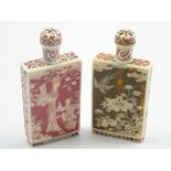 Near pair of red and black painted ivory bottles decorated with panels of figures and birds,