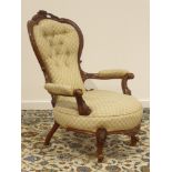 Victorian walnut framed open armchair, shaped cresting rail carved with flower heads,