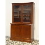 Victorian mahogany bookcase on cupboard, two glazed doors enclosing two adjustable shelves,