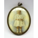 Early 20th century miniature oval portrait on ivory of a child, full length, indistinctly signed,