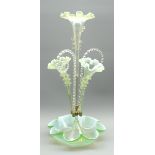 Green tinted vaseline glass epergne with 3 trumpet shape vases and 2 canes on a crimped circular