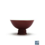 A copper-red stem bowl decorated with a rich copper-red glaze, Qing Dynasty, Qianlong seal mark