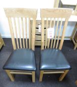 Two oak framed leather cushioned dining chairs (Showroom Furniture)