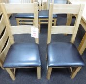 Two oak framed leather cushioned dining chairs (Showroom Furniture)