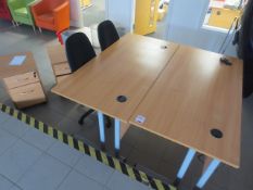 Two light-wood office desks, twin matching twin door pedestals and two black cloth upholstered