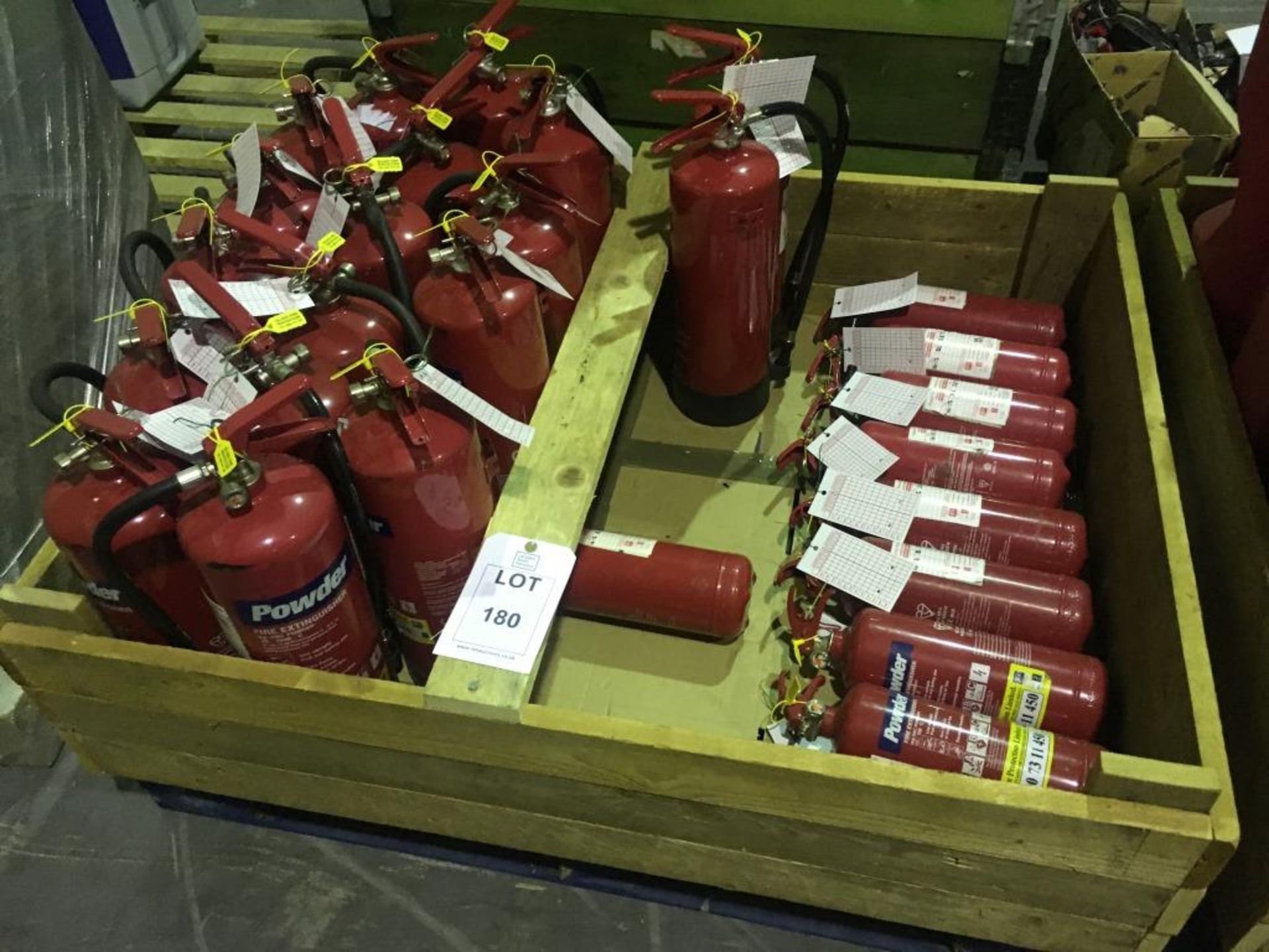 Assorted fire extinguishers and boxes on two pallets. Please note: This lot is