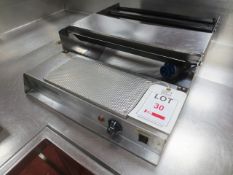 Stainless steel bench top film dispenser/heat sealer